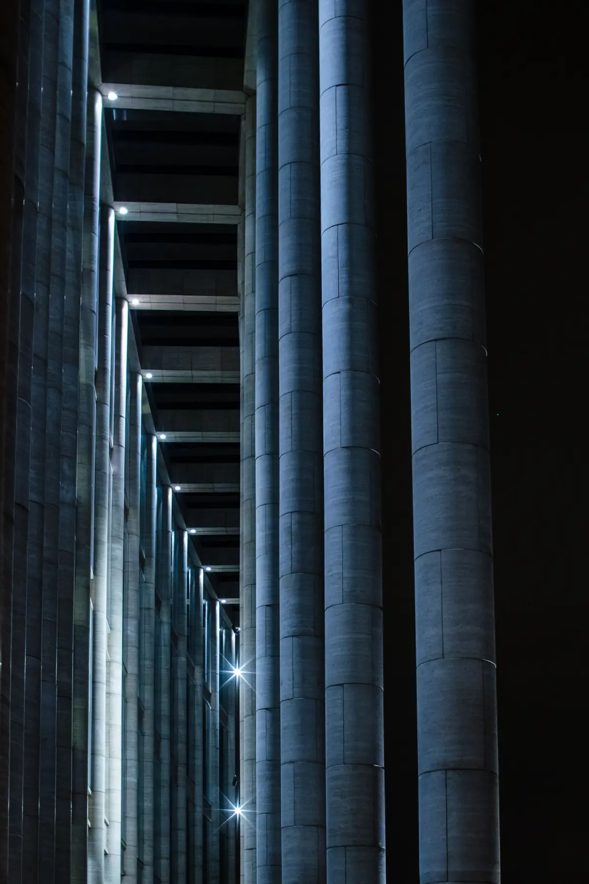 Dark concrete building lit at night